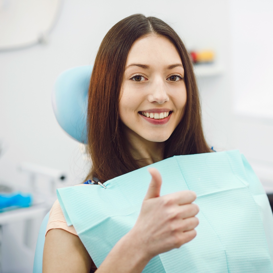 Beautiful patient sits in a chair at the dentist