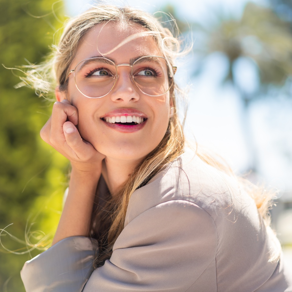 Pretty blonde Uruguayan woman with glasses at outdoors With happy expression