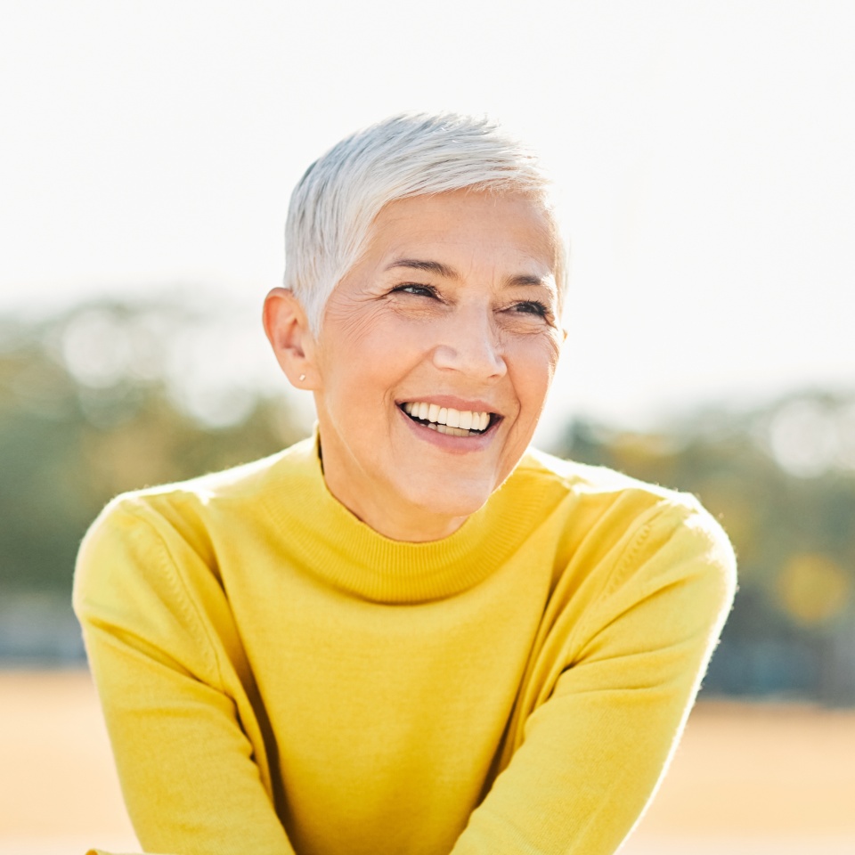 Portrait of an elderly woman outdoors. Happy senior woman in park