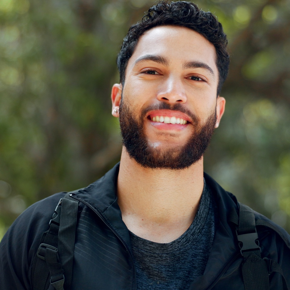 Young man portrait, nature hiking and freedom, travel and adventure in peace, calm and morning hike outdoors. Happy, fitness and smile arab guy, trekking travel and summer park in Egypt environment