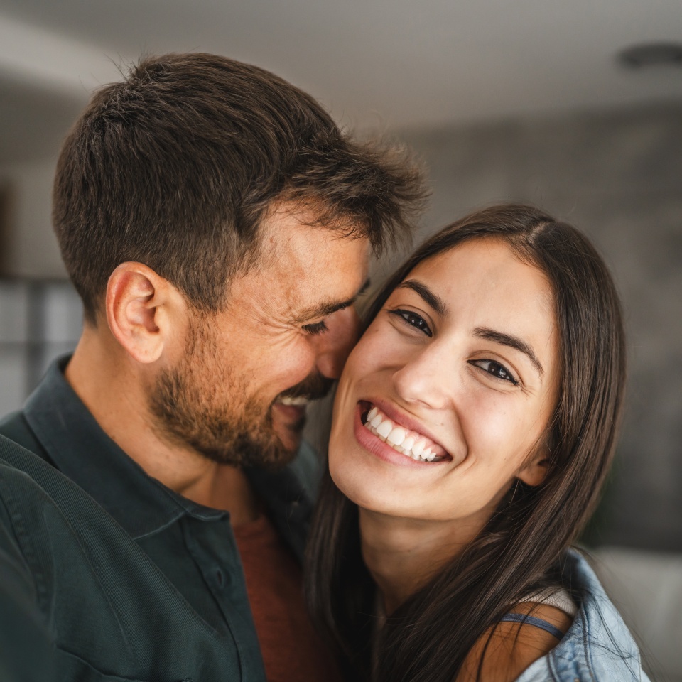 Self portrait of happy couple hug and have fun at home
