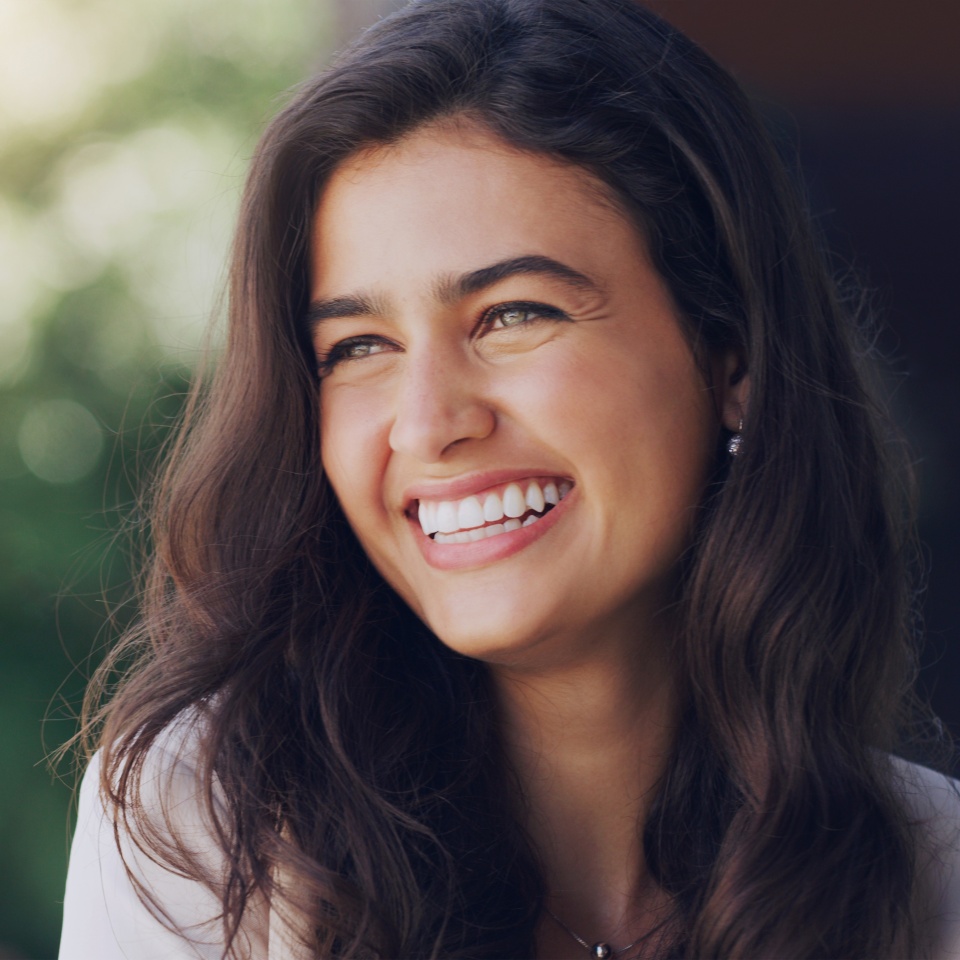 Happy, woman and face in nature for thinking, positive mindset and carefree with mockup space. Female person, smile and inspiration in natural environment for wellness, peace and relaxing in Portugal