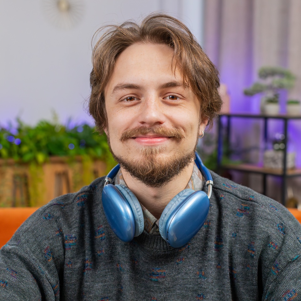 Close-up face portrait of happy calm man at home table smiling friendly, glad expression looking away dreaming resting, relaxation feel satisfied good news, celebrate win. Caucasian guy in office room