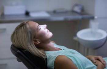 Woman relaxing on dentist chair in dental clinic